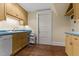Functional kitchenette with blue countertops, wooden cabinetry, and hardwood floors at 3105 Cone Manor Ln, Raleigh, NC 27613
