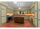 Well-equipped laundry room with ample cabinet space, washer and dryer, and folding table at 3105 Cone Manor Ln, Raleigh, NC 27613