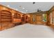 Large living room with wood paneling, built-in shelving, and backyard views at 3105 Cone Manor Ln, Raleigh, NC 27613