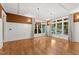 Bright, open living room featuring hardwood floors, large windows, and elegant chandeliers at 3105 Cone Manor Ln, Raleigh, NC 27613