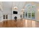 Spacious living room with fireplace, large windows, and vaulted ceilings with chandeliers at 3105 Cone Manor Ln, Raleigh, NC 27613