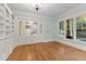 Inviting living room with hardwood floors, built-in shelving, and elegant French doors at 3105 Cone Manor Ln, Raleigh, NC 27613