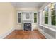 Cozy living room featuring a decorative fireplace, natural light, and custom shelving at 3105 Cone Manor Ln, Raleigh, NC 27613