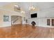 Expansive living room with fireplace, built-in cabinetry, hardwood floors, and staircase at 3105 Cone Manor Ln, Raleigh, NC 27613