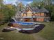 Gorgeous custom pool and fire pit area are shown in the backyard of this luxury home at 3105 Cone Manor Ln, Raleigh, NC 27613
