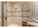 Luxurious walk-in shower features neutral tile, with built in bench and glass surround at 3105 Cone Manor Ln, Raleigh, NC 27613