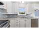 Modern kitchen featuring granite countertops, stainless appliances, and bright white cabinetry at 141 Kent St, Youngsville, NC 27596