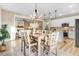 Open concept dining and living area with white cabinets, stainless appliances, and a cozy fireplace at 9314 Turkey Way, Middlesex, NC 27557