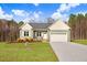 Charming single-story home with a two-car garage, well-maintained lawn, and inviting front entrance at 9314 Turkey Way, Middlesex, NC 27557