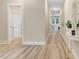 Bright hallway with wood-style floors, neutral paint and ample natural light, creating a welcoming path through the home at 9314 Turkey Way, Middlesex, NC 27557