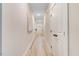 Inviting hallway with wood-look flooring, neutral walls, and modern lighting, leading to a bright and airy interior at 9314 Turkey Way, Middlesex, NC 27557