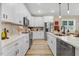 Charming kitchen with white countertops, stainless steel appliances, and stylish backsplash, creating a warm and inviting space at 9314 Turkey Way, Middlesex, NC 27557