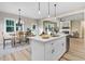 Modern kitchen with stainless steel appliances, an island with a sink, and an adjacent dining area and living room at 9314 Turkey Way, Middlesex, NC 27557