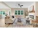 Inviting living room featuring a cozy fireplace, neutral color palette, and lots of natural light at 9314 Turkey Way, Middlesex, NC 27557