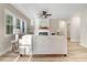 Neutral living space featuring an elegant fireplace, fan, and large windows with views of the outdoors at 9314 Turkey Way, Middlesex, NC 27557