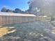 Spacious backyard featuring a new, light colored wooden fence and grass lawn at 1011 Lemon Dr, Durham, NC 27705