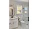 Modern bathroom featuring marble floors, a glass shower, and a white vanity at 1011 Lemon Dr, Durham, NC 27705