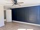 Empty bedroom featuring hardwood floors and a stylish, paneled accent wall at 1011 Lemon Dr, Durham, NC 27705