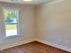 Bright bedroom featuring hardwood floors and a window with a view of the outdoors at 1011 Lemon Dr, Durham, NC 27705