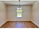 Well-lit dining room with a large window, hardwood floors and shiplap accent wall at 1011 Lemon Dr, Durham, NC 27705