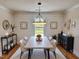 Bright dining room with modern light fixture, plank accent wall, and hardwood floors at 1011 Lemon Dr, Durham, NC 27705