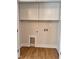 Laundry room area featuring hardwood floors, white cabinets, and utility hookups at 1011 Lemon Dr, Durham, NC 27705