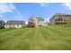 Expansive backyard with lush lawn, mature trees, and wooden deck, ideal for outdoor activities and relaxation at 2024 Stanchion St, Haw River, NC 27258