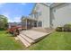 Multi-level wooden deck and patio space with colorful flowers, perfect for outdoor entertaining or relaxation at 2024 Stanchion St, Haw River, NC 27258