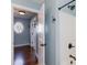 Powder blue bathroom featuring a modern vanity with black hardware and shower and hardwood floors beyond the doorway at 2024 Stanchion St, Haw River, NC 27258