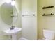 Bathroom includes pedestal sink, vanity mirror and modern fixtures at 2024 Stanchion St, Haw River, NC 27258