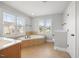 Bright bathroom boasts a garden tub and a window with a view at 2024 Stanchion St, Haw River, NC 27258