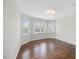 Sunlit bedroom boasts hardwood floors and two large windows at 2024 Stanchion St, Haw River, NC 27258