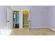 A view from inside a bedroom into the attached closet, showing custom organizers and ample storage at 2024 Stanchion St, Haw River, NC 27258