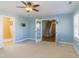 Bedroom featuring light blue walls and doorway to staircase at 2024 Stanchion St, Haw River, NC 27258