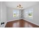 Hardwood floors shine in this bedroom, featuring a modern light fixture and abundant light at 2024 Stanchion St, Haw River, NC 27258