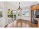 Sunlit breakfast nook with hardwood floors, large windows, and a sliding glass door leading to the deck at 2024 Stanchion St, Haw River, NC 27258
