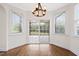 Bright breakfast nook features hardwood floors, windows, and sliding door accessing a deck at 2024 Stanchion St, Haw River, NC 27258
