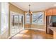Bright dining area features hardwood floors, slider doors to deck, and modern chandelier at 2024 Stanchion St, Haw River, NC 27258