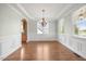 Formal dining room boasts hardwood floors, wainscoting, and abundant natural light at 2024 Stanchion St, Haw River, NC 27258