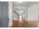 Bright and airy foyer with hardwood floors, crown molding, and staircase at 2024 Stanchion St, Haw River, NC 27258