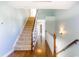 Light-filled hallway with hardwood floors, carpeted stairs, and white trim at 2024 Stanchion St, Haw River, NC 27258