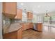 Bright kitchen boasts granite countertops, wooden cabinetry, and modern stainless steel appliances at 2024 Stanchion St, Haw River, NC 27258