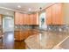 Kitchen features granite countertops, maple cabinetry, and tile backsplash at 2024 Stanchion St, Haw River, NC 27258