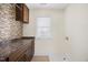 Laundry room featuring a window and stylish backsplash at 2024 Stanchion St, Haw River, NC 27258