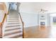 Living room features hardwood floors, fireplace, and stairs to upper floor at 2024 Stanchion St, Haw River, NC 27258