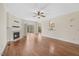 Inviting living room with fireplace, hardwood floors, ceiling fan, and sliding glass doors leading to the outside at 2024 Stanchion St, Haw River, NC 27258