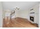 Spacious living room with hardwood floors, fireplace, staircase and bright natural light at 2024 Stanchion St, Haw River, NC 27258