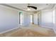 Expansive primary bedroom featuring a tray ceiling, carpeted floors, and multiple doorways at 2024 Stanchion St, Haw River, NC 27258