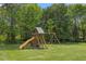 Backyard playset with slide and swings, providing hours of outdoor fun for children in a green setting at 2024 Stanchion St, Haw River, NC 27258