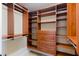 Spacious walk-in closet with custom dark wood shelving and drawers for optimal organization at 2024 Stanchion St, Haw River, NC 27258